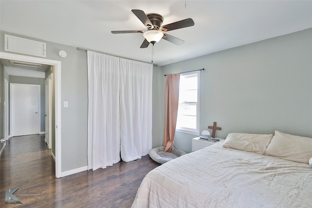 bedroom featuring baseboards, visible vents, ceiling fan, and dark wood-style flooring