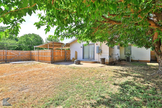 view of yard with a patio area, a fenced backyard, and central air condition unit