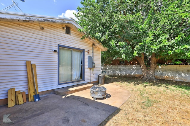 exterior space featuring a patio area, fence, and a fire pit