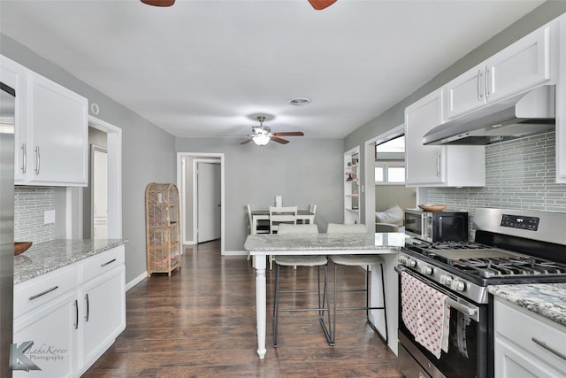 kitchen featuring under cabinet range hood, white cabinetry, visible vents, and appliances with stainless steel finishes