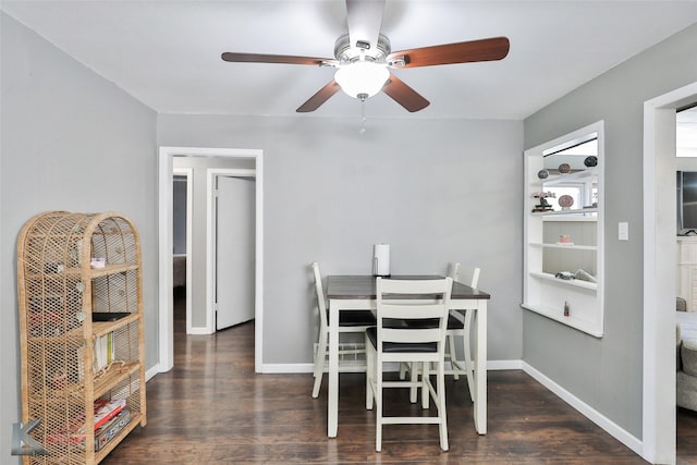 dining area with a ceiling fan, baseboards, and wood finished floors