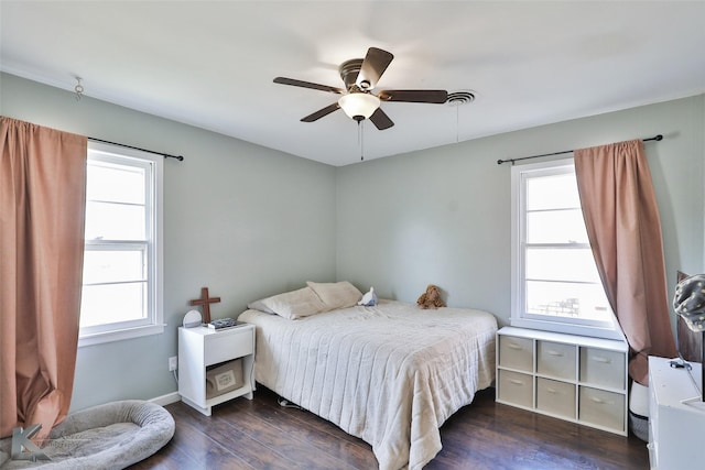 bedroom featuring baseboards, a ceiling fan, and wood finished floors