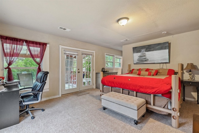 bedroom with access to outside, french doors, visible vents, and carpet