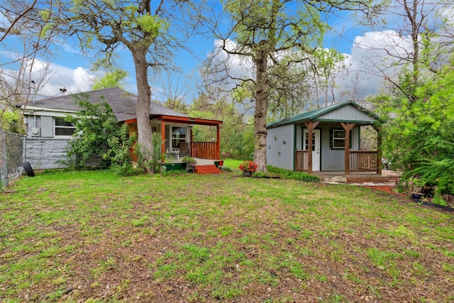 view of yard with a porch and fence