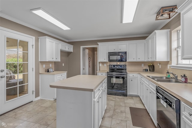 kitchen with ornamental molding, light countertops, a sink, and black appliances