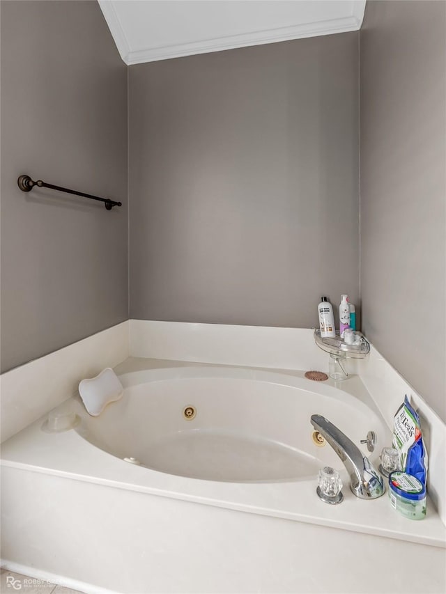 bathroom featuring a whirlpool tub and crown molding