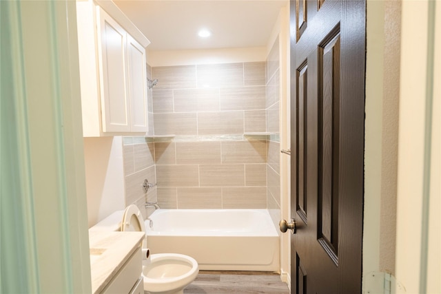 bathroom with wood finished floors, toilet, shower / tub combination, and vanity