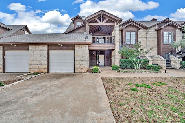 view of front of house featuring a shingled roof, concrete driveway, a balcony, and an attached garage