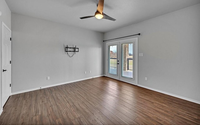 unfurnished room featuring ceiling fan, dark wood-type flooring, and baseboards