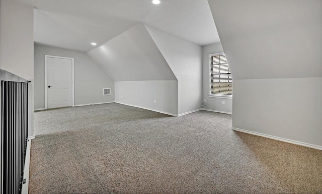 bonus room with carpet flooring, vaulted ceiling, visible vents, and baseboards