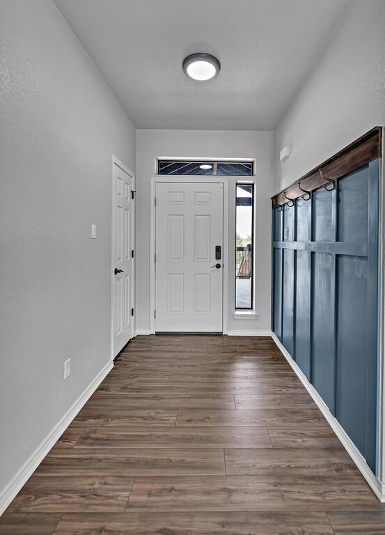 entrance foyer with baseboards and wood finished floors