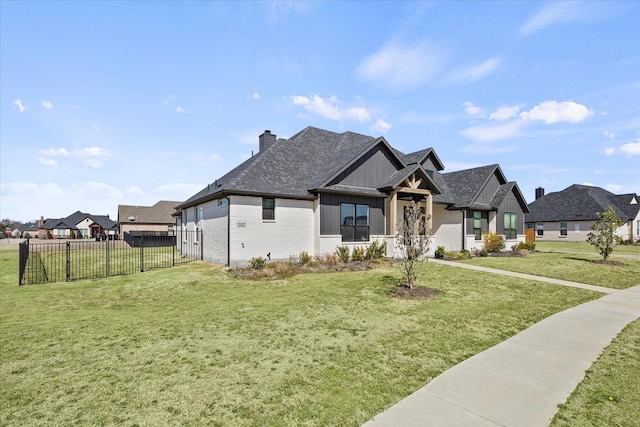 view of front of property with brick siding, fence, a residential view, a front lawn, and a chimney