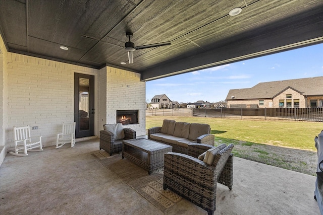 1024 Todd St, Caddo Mills, TX 75135 - view of patio / terrace with a ceiling fan, a fenced backyard, and an outdoor living space with a fireplace