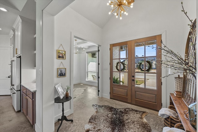 1024 Todd St, Caddo Mills, TX 75135 - entrance foyer featuring baseboards, a chandelier, french doors, concrete floors, and high vaulted ceiling