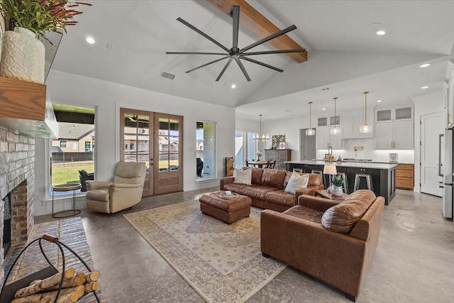 1024 Todd St, Caddo Mills, TX 75135 - living area featuring french doors, a fireplace, high vaulted ceiling, concrete flooring, and beamed ceiling