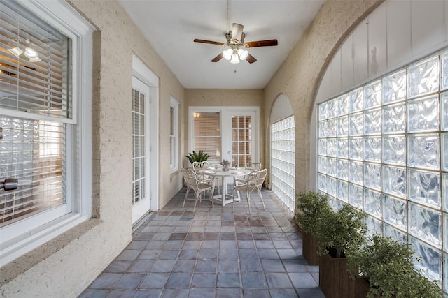 sunroom with a ceiling fan