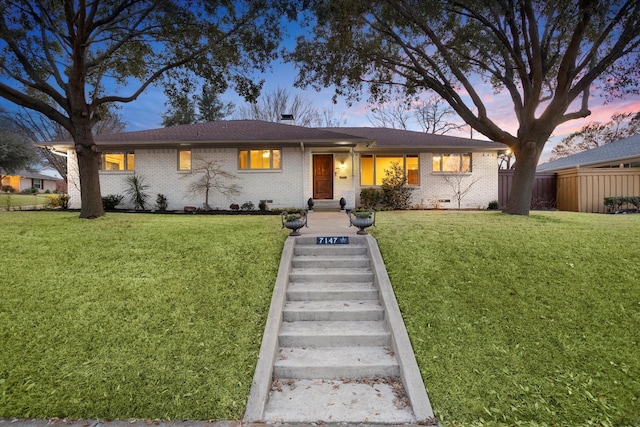 single story home featuring a front yard, crawl space, and fence