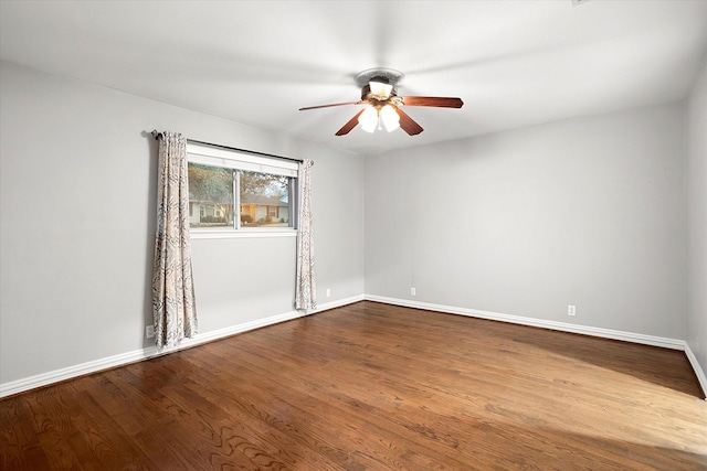 unfurnished room with ceiling fan, baseboards, and wood finished floors