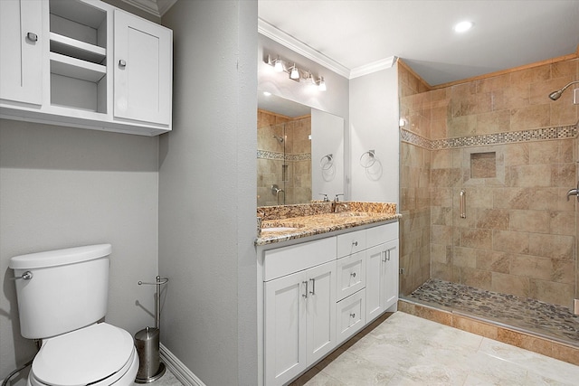 bathroom with vanity, ornamental molding, a shower stall, and toilet