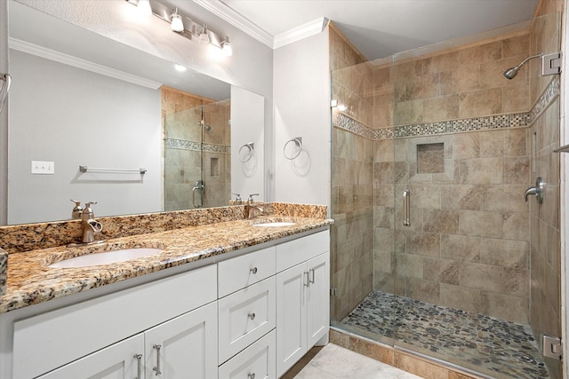 full bath featuring ornamental molding, a sink, a shower stall, and double vanity