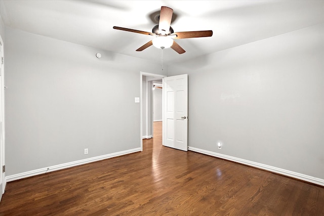 spare room featuring a ceiling fan, baseboards, and wood finished floors