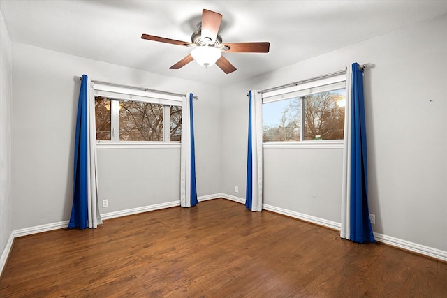 unfurnished room featuring a ceiling fan, baseboards, and wood finished floors