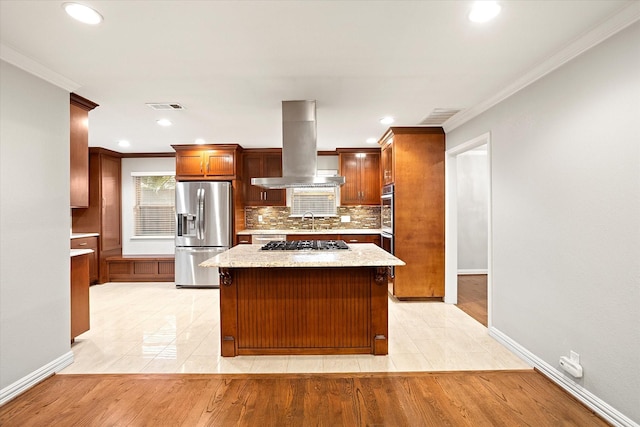 kitchen featuring visible vents, island exhaust hood, appliances with stainless steel finishes, and tasteful backsplash