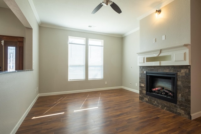 unfurnished living room featuring dark wood-style floors, crown molding, and a tiled fireplace