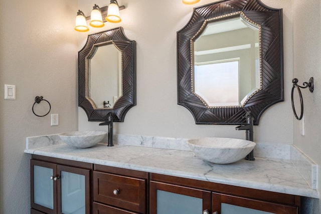 full bathroom featuring a sink and double vanity