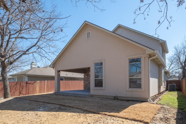 back of property with a patio, fence, cooling unit, and stucco siding