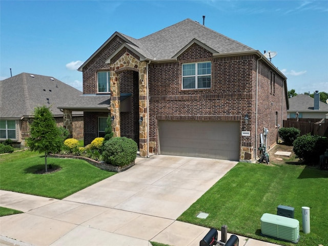 1009 Lake Forest Trl, Little Elm, TX 75068 - traditional home with an attached garage, stone siding, brick siding, roof with shingles, and concrete driveway