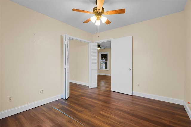 empty room featuring ceiling fan, baseboards, and wood finished floors