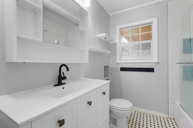 bathroom with crown molding, vanity, toilet, and baseboards