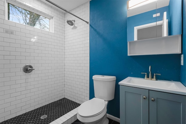 bathroom with toilet, a stall shower, and vanity