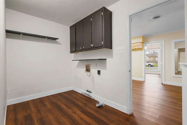 laundry room with cabinet space, baseboards, visible vents, dark wood-style flooring, and washer hookup