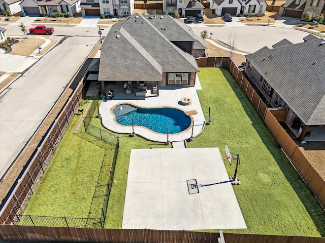 view of swimming pool featuring a fenced backyard, a residential view, a fenced in pool, and a patio