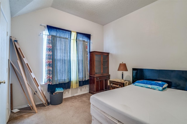 carpeted bedroom with lofted ceiling, baseboards, and a textured ceiling