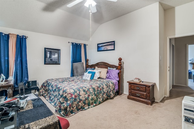 bedroom with heating unit, a textured ceiling, carpet flooring, ceiling fan, and vaulted ceiling