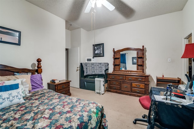 carpeted bedroom featuring a textured ceiling and ceiling fan