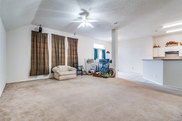 unfurnished room featuring visible vents, light carpet, and a textured ceiling