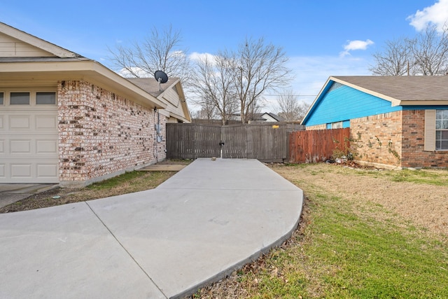 view of yard featuring fence and a gate