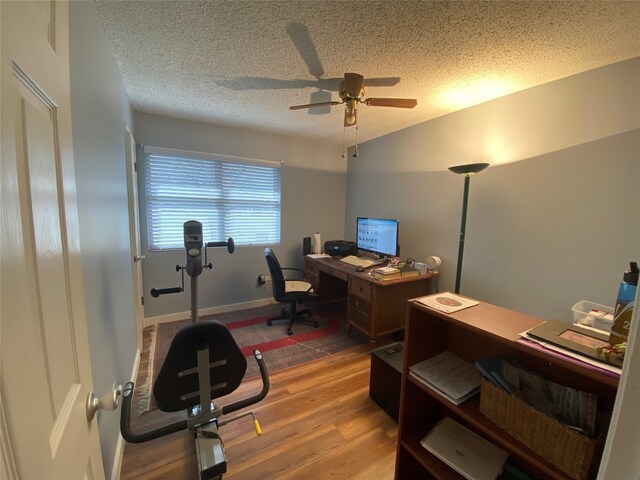 bedroom with carpet, baseboards, and a textured ceiling