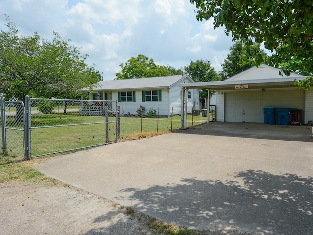 ranch-style home featuring a fenced front yard, a gate, a detached garage, and a front lawn