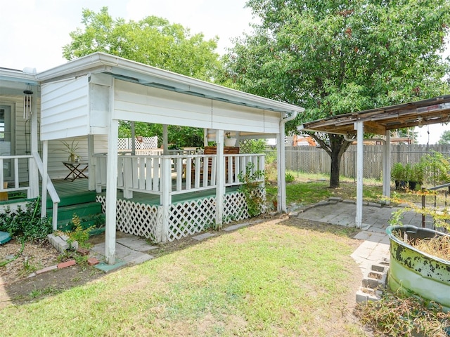 view of yard featuring fence and a wooden deck