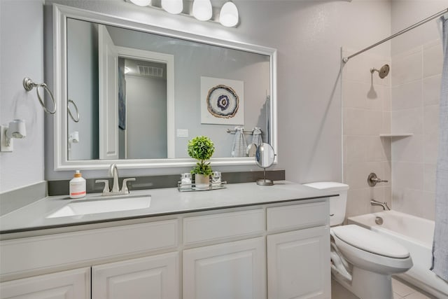 full bath featuring visible vents, bathtub / shower combination, vanity, and toilet