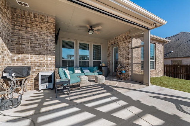 view of patio with visible vents, a ceiling fan, an outdoor hangout area, heating unit, and fence