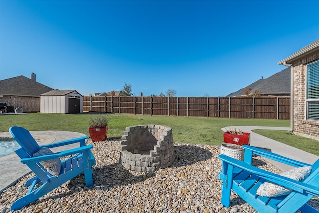 view of yard featuring a fenced backyard, a patio, a fire pit, and a shed