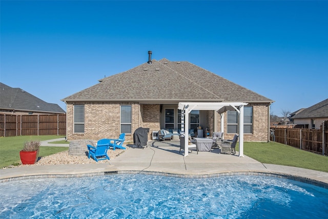 rear view of property with a patio area, brick siding, an outdoor living space, and a fenced backyard