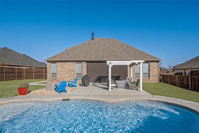 view of swimming pool featuring a lawn, a patio area, and a fenced backyard