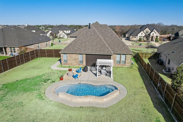 view of yard with a storage shed, a fenced backyard, an outbuilding, a patio area, and a pergola